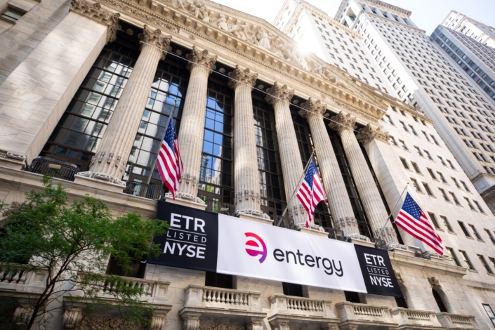 Entergy stock symbol and logo signs at the New York Stock Exchange